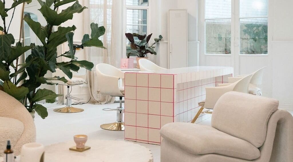 Modern salon interior at STYLD, Bath, England, GB with stylish furniture and lush plants.