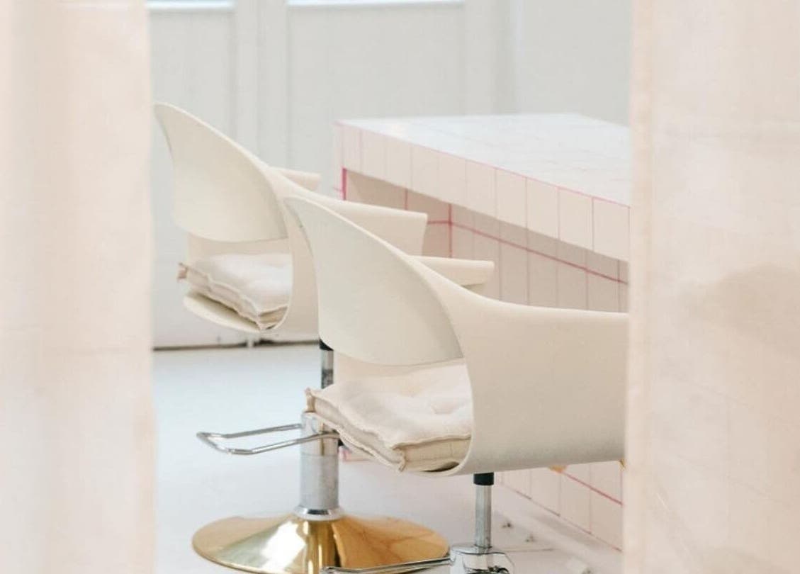 Modern salon chairs at STYLD in Bath, England, GB featuring sleek design and comfortable seating.