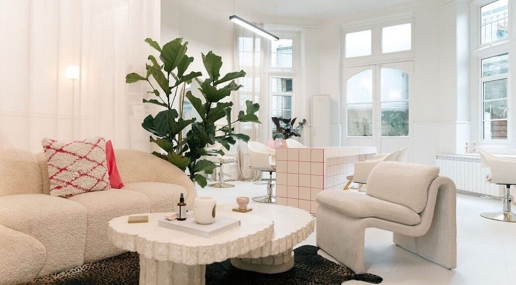 Elegant modern interior of STYLD in Bath, England, GB, featuring plush seating and greenery.