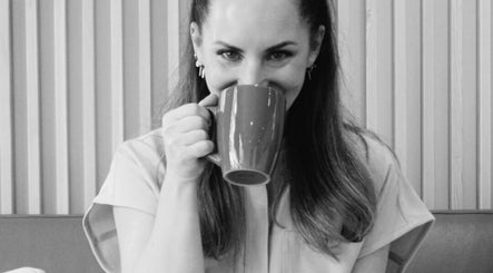 Guest enjoys coffee at Sian Aesthetics North London Highgate, London, England, GB, highlighting a relaxing atmosphere.