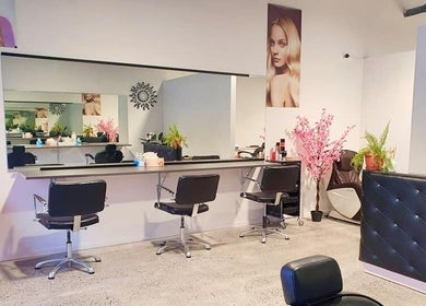 Modern salon interior at Style and Smile Beauty Parlour, Hamilton, Waikato, NZ, featuring elegant styling stations.