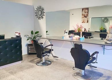 Cozy interior of Style and Smile Beauty Parlour, Hamilton, Waikato, NZ with stylish chairs and mirrors.