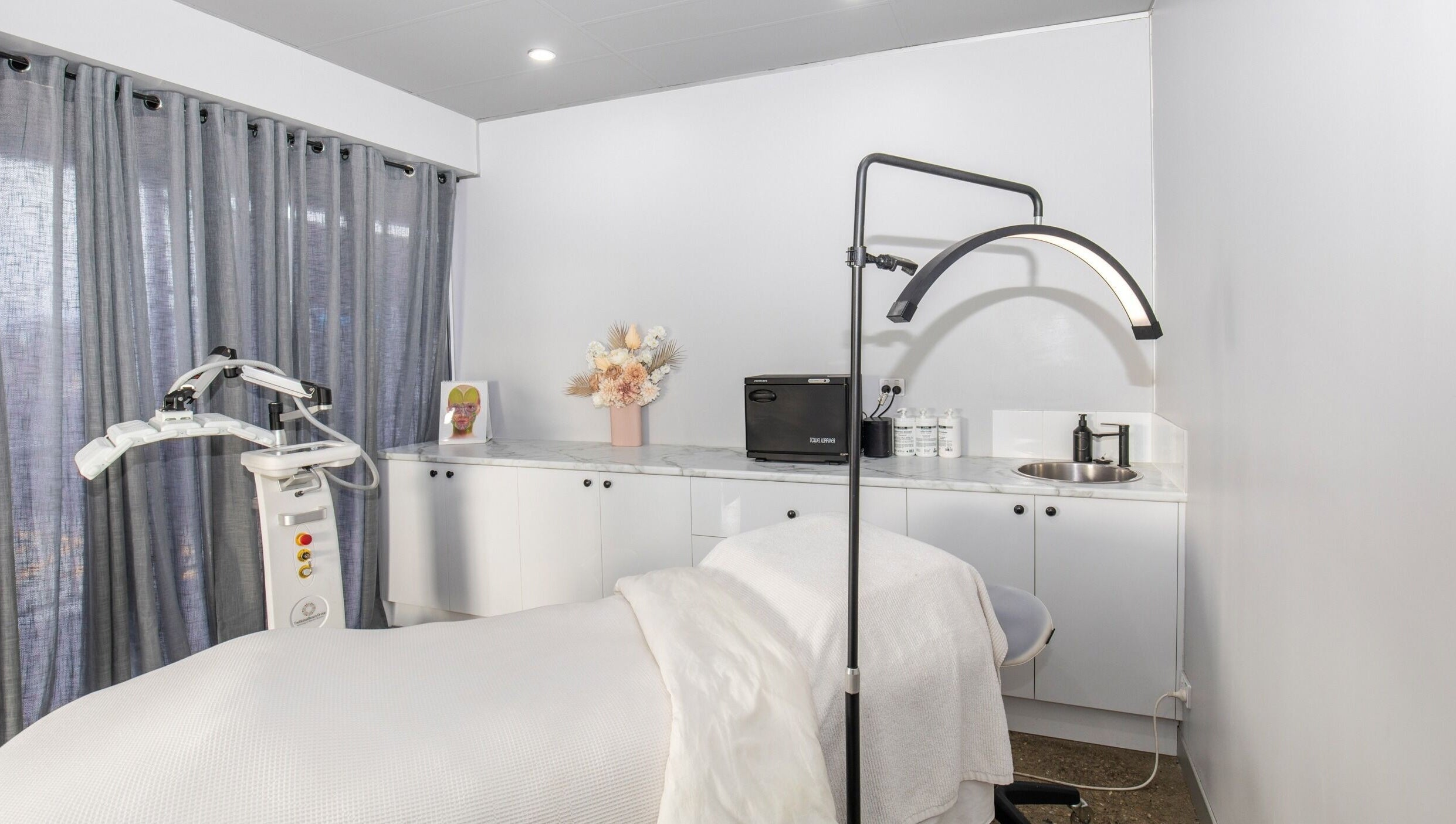 Calm and inviting treatment room at Skin at Bardon, Bardon, Queensland, AU, showcasing modern wellness equipment.