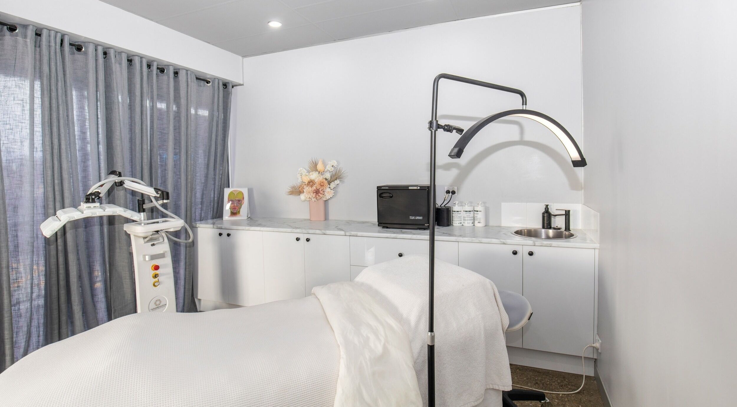 Calm and inviting treatment room at Skin at Bardon, Bardon, Queensland, AU, showcasing modern wellness equipment.