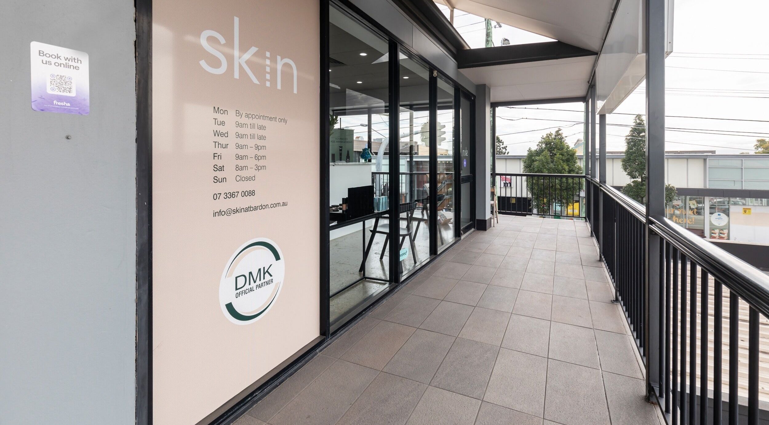 Entrance to Skin at Bardon, Bardon, Queensland, AU, showcasing modern glass facade and appointment details.