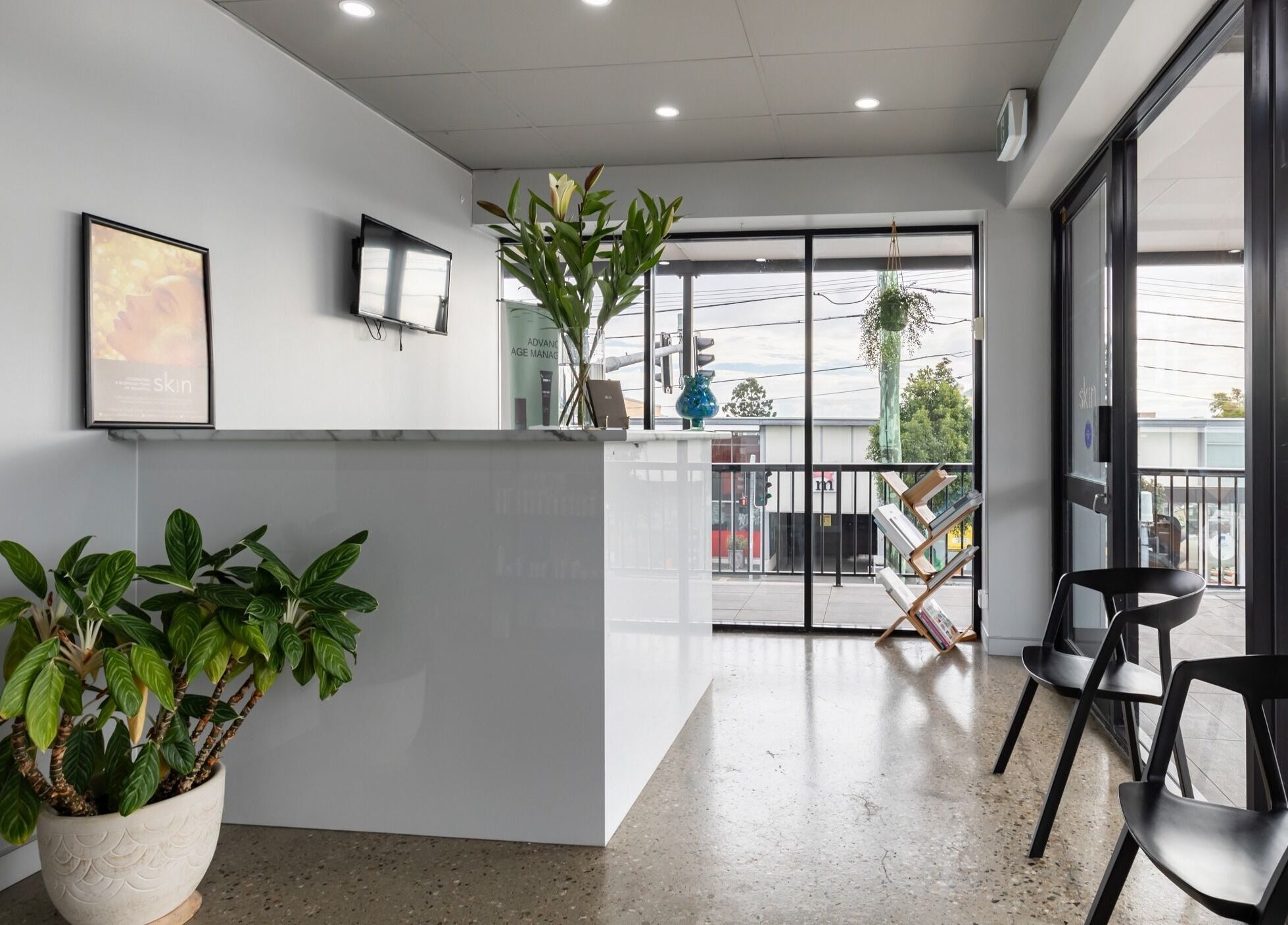 Bright and welcoming lobby of Skin at Bardon, located in Bardon, Queensland, AU, featuring plants and seating.