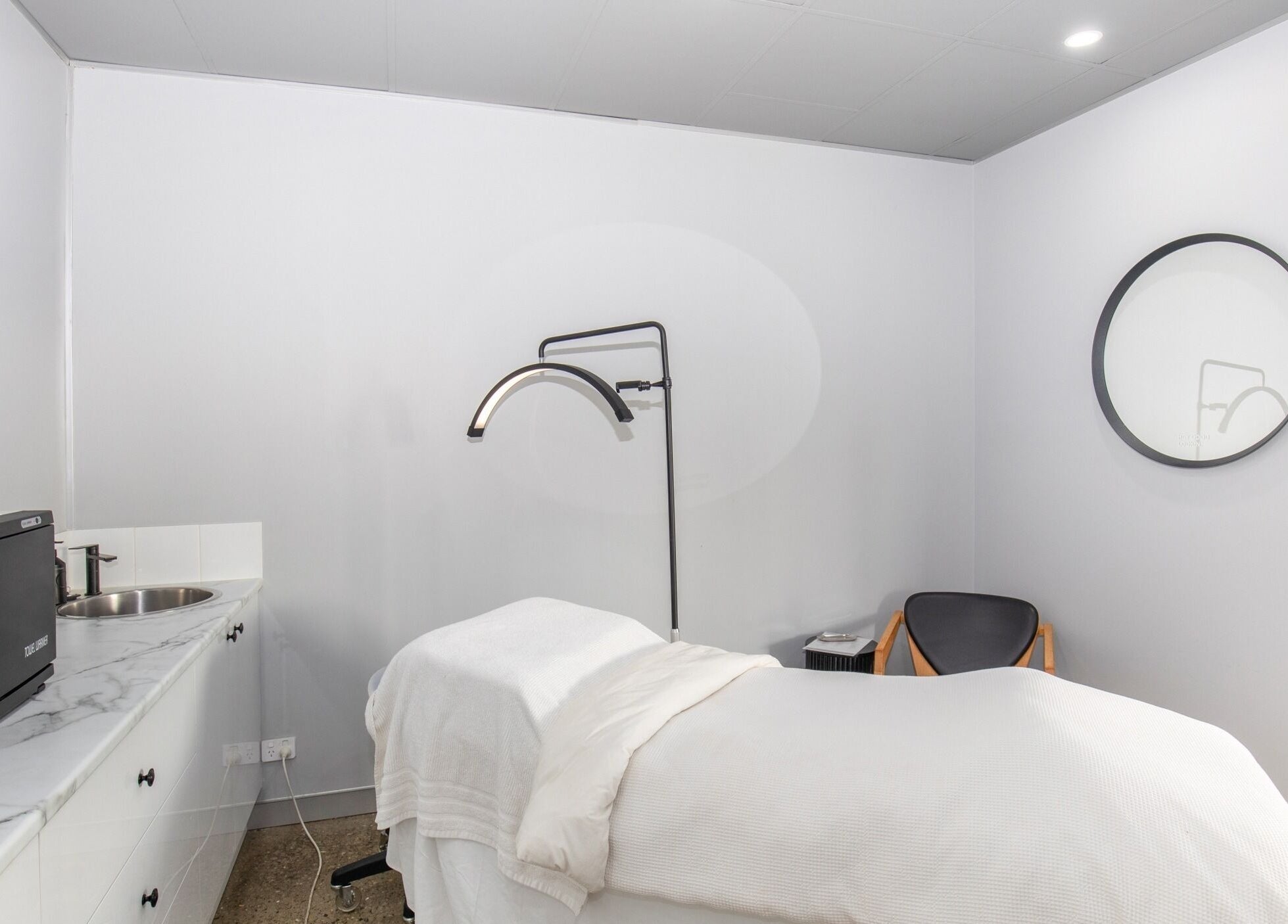 Tranquil spa room at Skin at Bardon, Bardon, Queensland, AU with treatment bed and modern decor.
