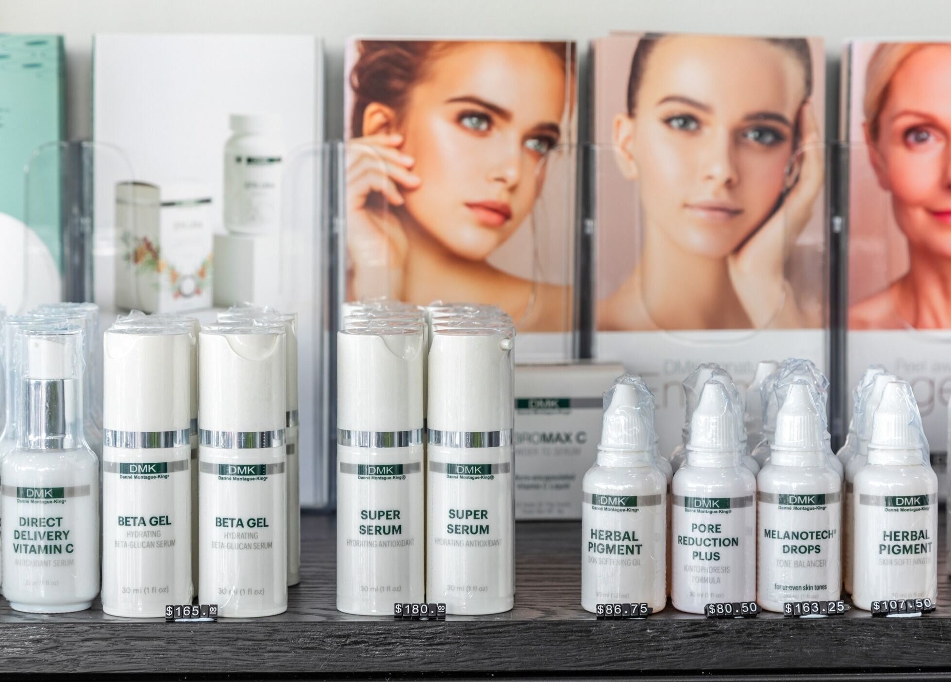 Skincare products at Skin at Bardon in Bardon, Queensland, AU. Display of serums and creams against beauty posters.