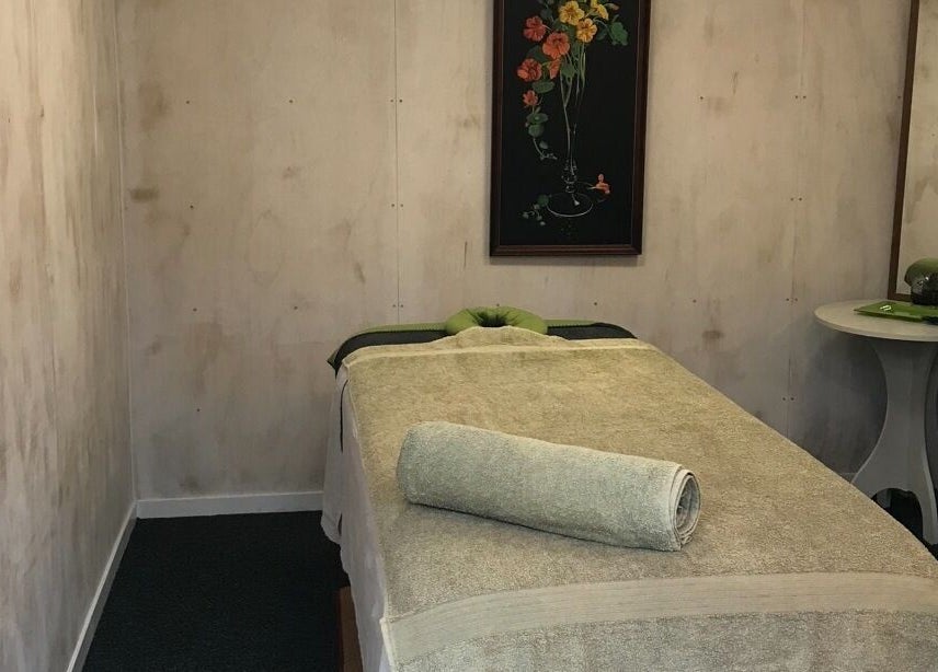 Cozy massage room at Balanz for Body, Auckland, NZ, featuring a treatment bed with soft towels.