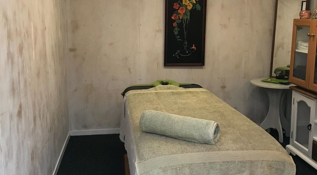 Cozy massage room at Balanz for Body, Auckland, NZ, featuring a treatment bed with soft towels.