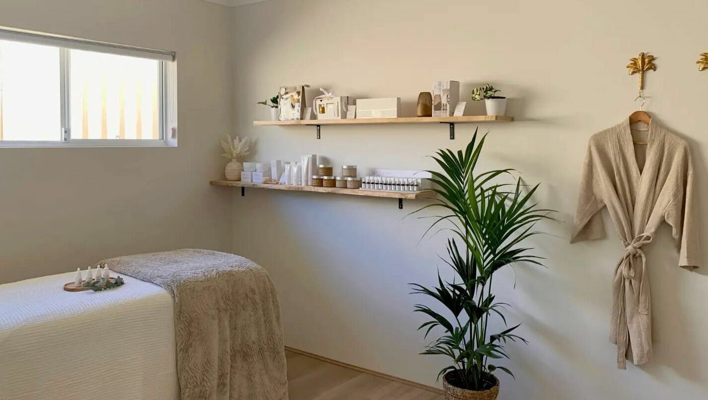 Calming spa room at The Beauty Room Florida Beach, Dawesville, Western Australia, AU with massage bed and shelves.