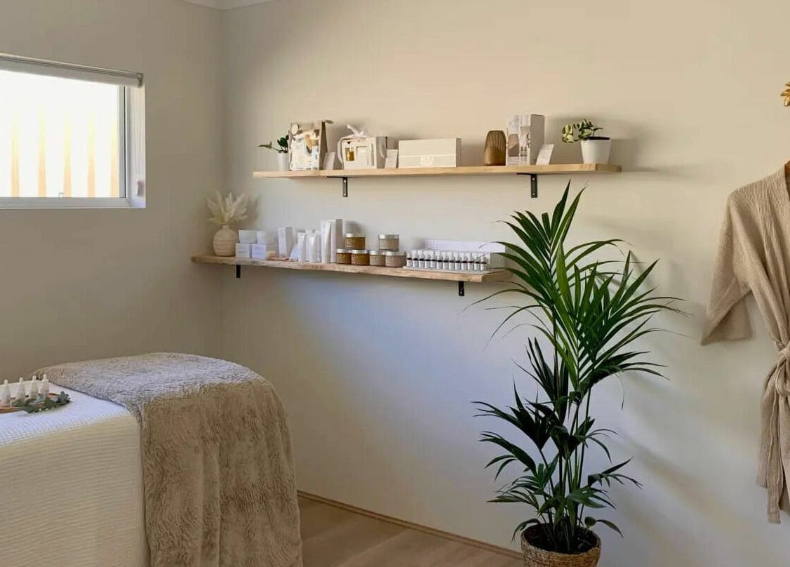Calming spa room at The Beauty Room Florida Beach, Dawesville, Western Australia, AU with massage bed and shelves.