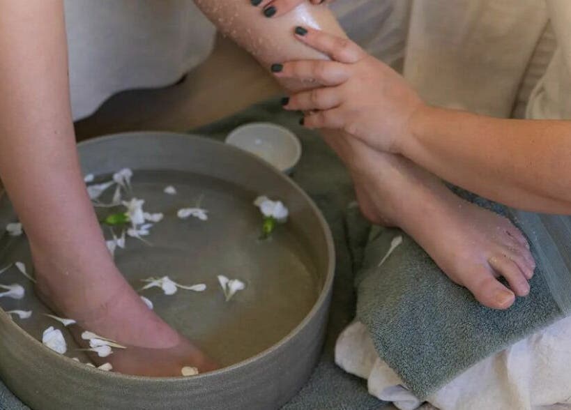 Foot spa treatment at The Beauty Room Florida Beach, Dawesville, Western Australia, AU with petals in water.
