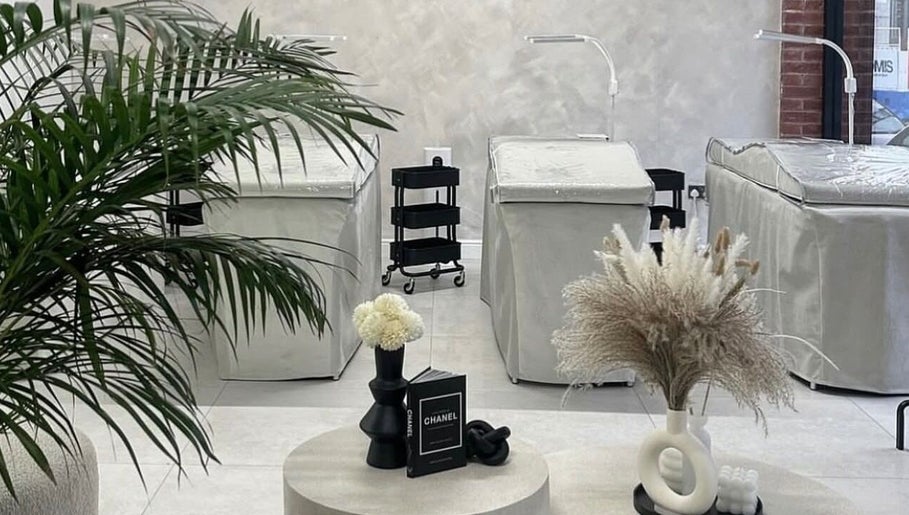 Modern interior of CarlyCosmeticTattoo in Manchester, England, GB, featuring stylish décor and treatment beds.
