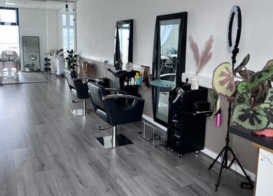 Modern salon interior at The Beauty Deck, Portland, England, GB. Stylish chairs and mirrors enhance elegance.