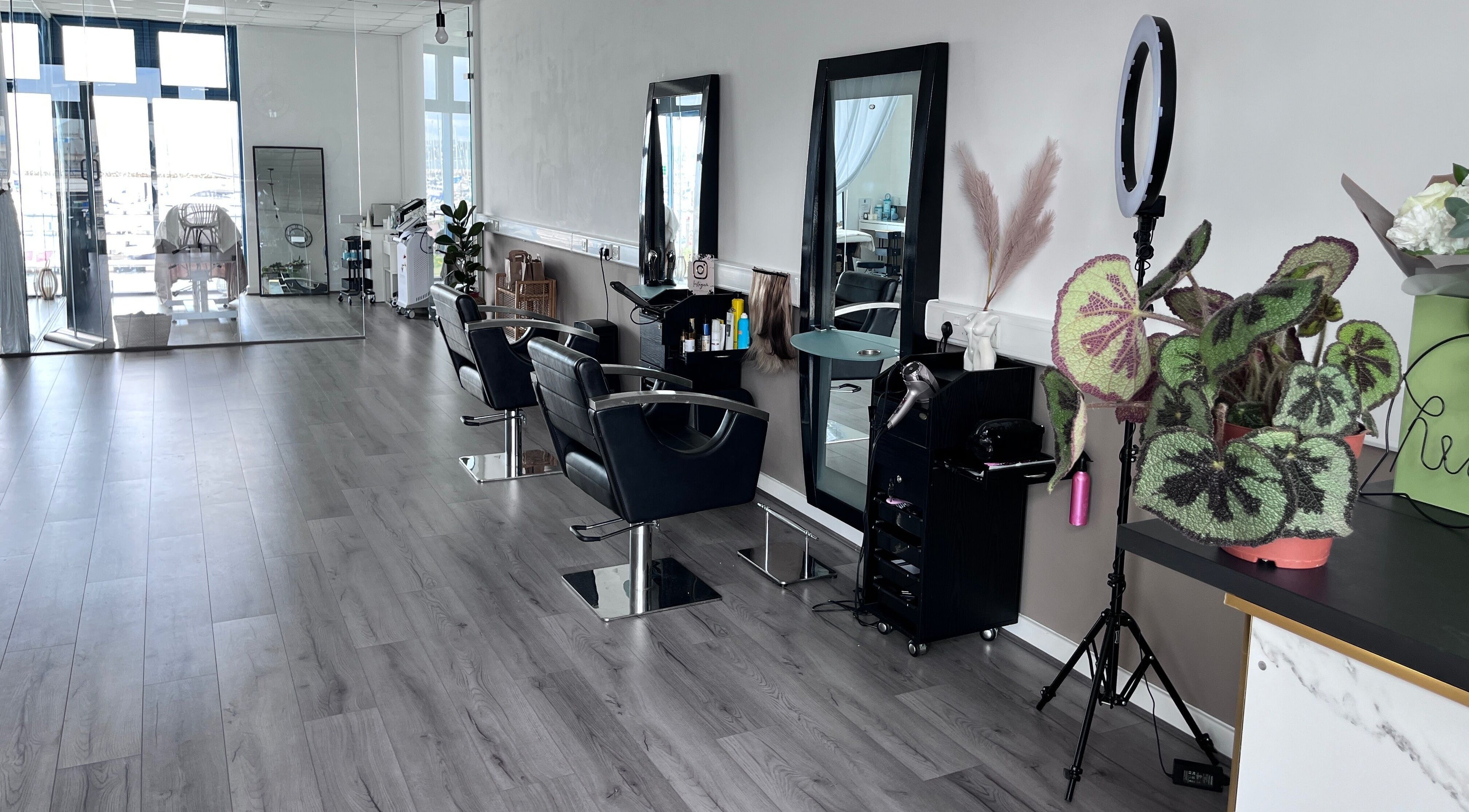 Modern salon interior at The Beauty Deck, Portland, England, GB. Stylish chairs and mirrors enhance elegance.