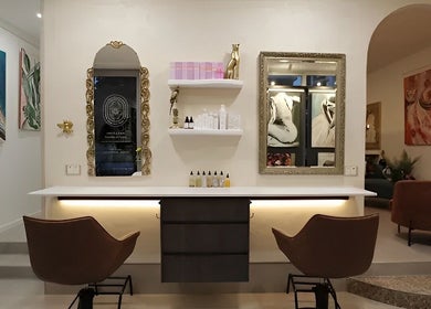 Luxurious interior of Sass & Soul Hair Studio in Maroochydore, Queensland, AU, featuring elegant decor and art.
