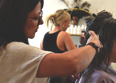 A stylist skillfully cuts hair at Sass & Soul Hair Studio, Maroochydore, Queensland, AU.