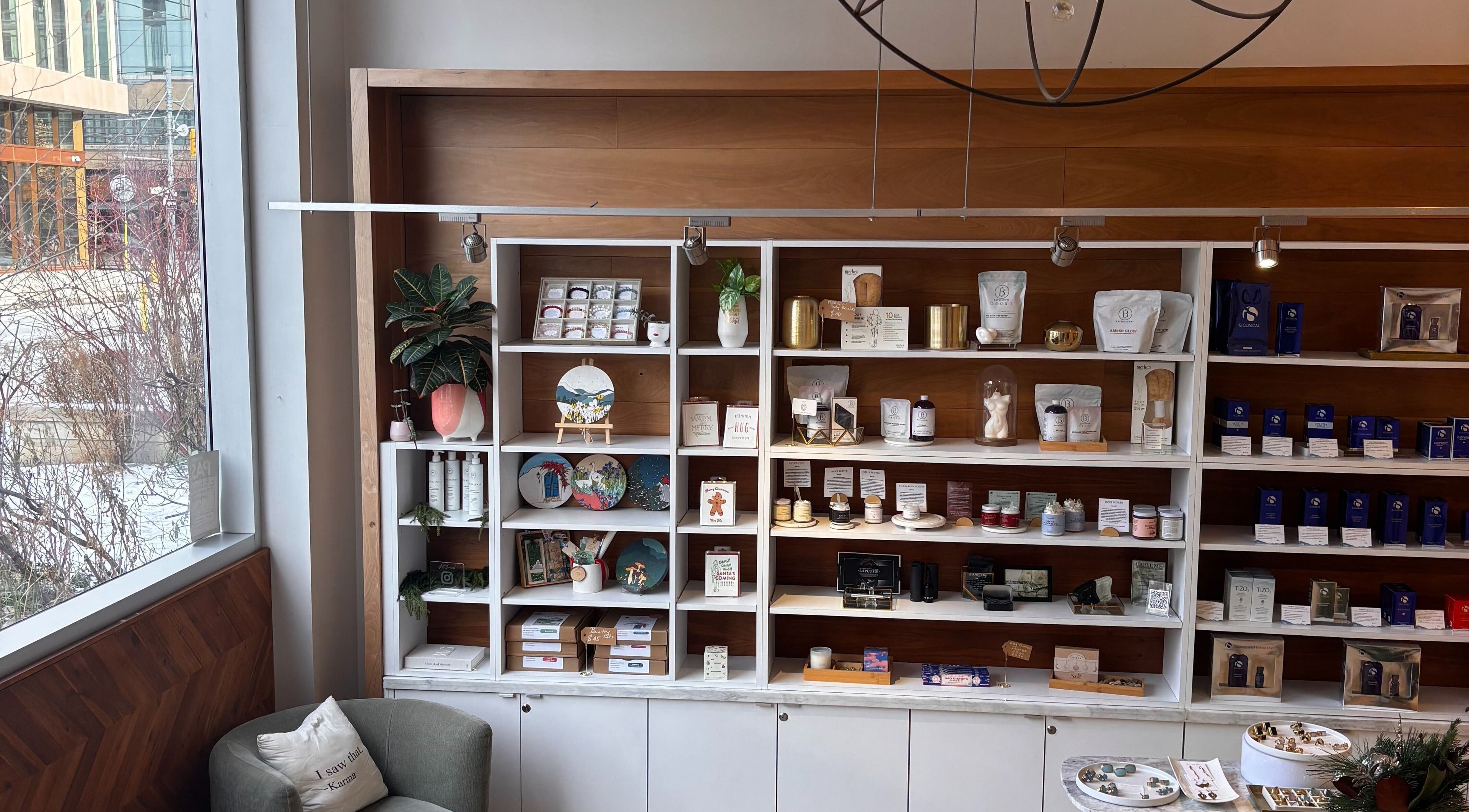 Ritual Beauty & Wellness Toronto, ON, CA features a stylish shelf with products and a cozy seating area.