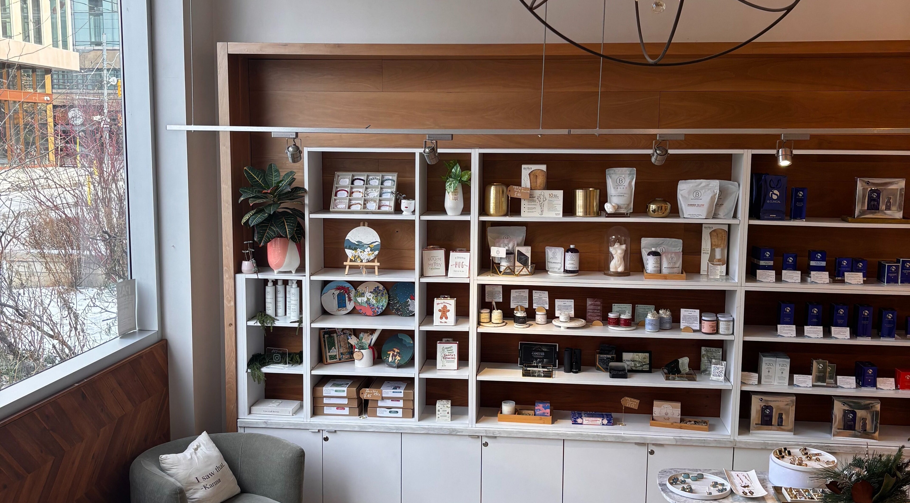 Ritual Beauty & Wellness Toronto, ON, CA features a stylish shelf with products and a cozy seating area.