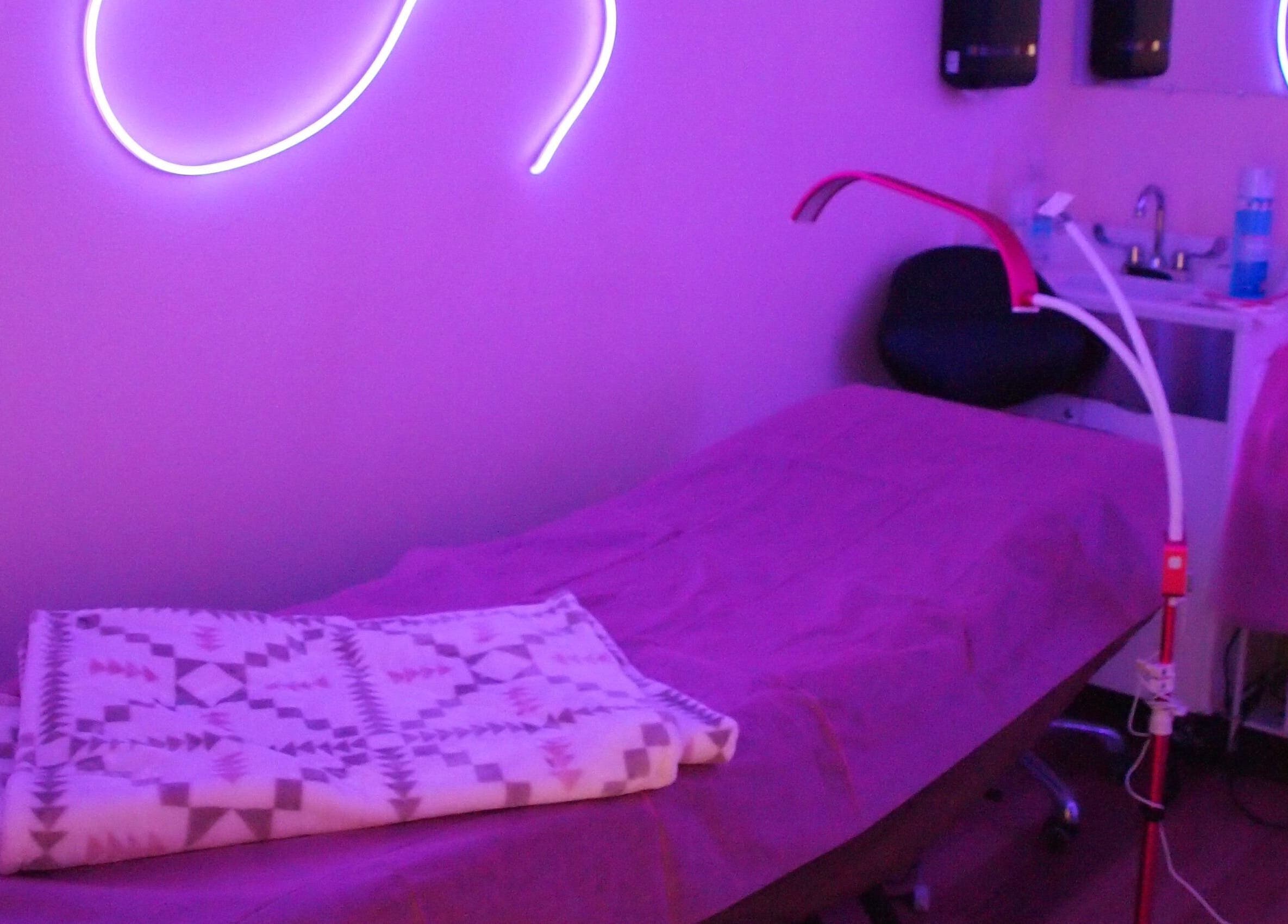 Tranquil treatment room at European Beauty, Everett, Washington, US, featuring soothing purple lighting.