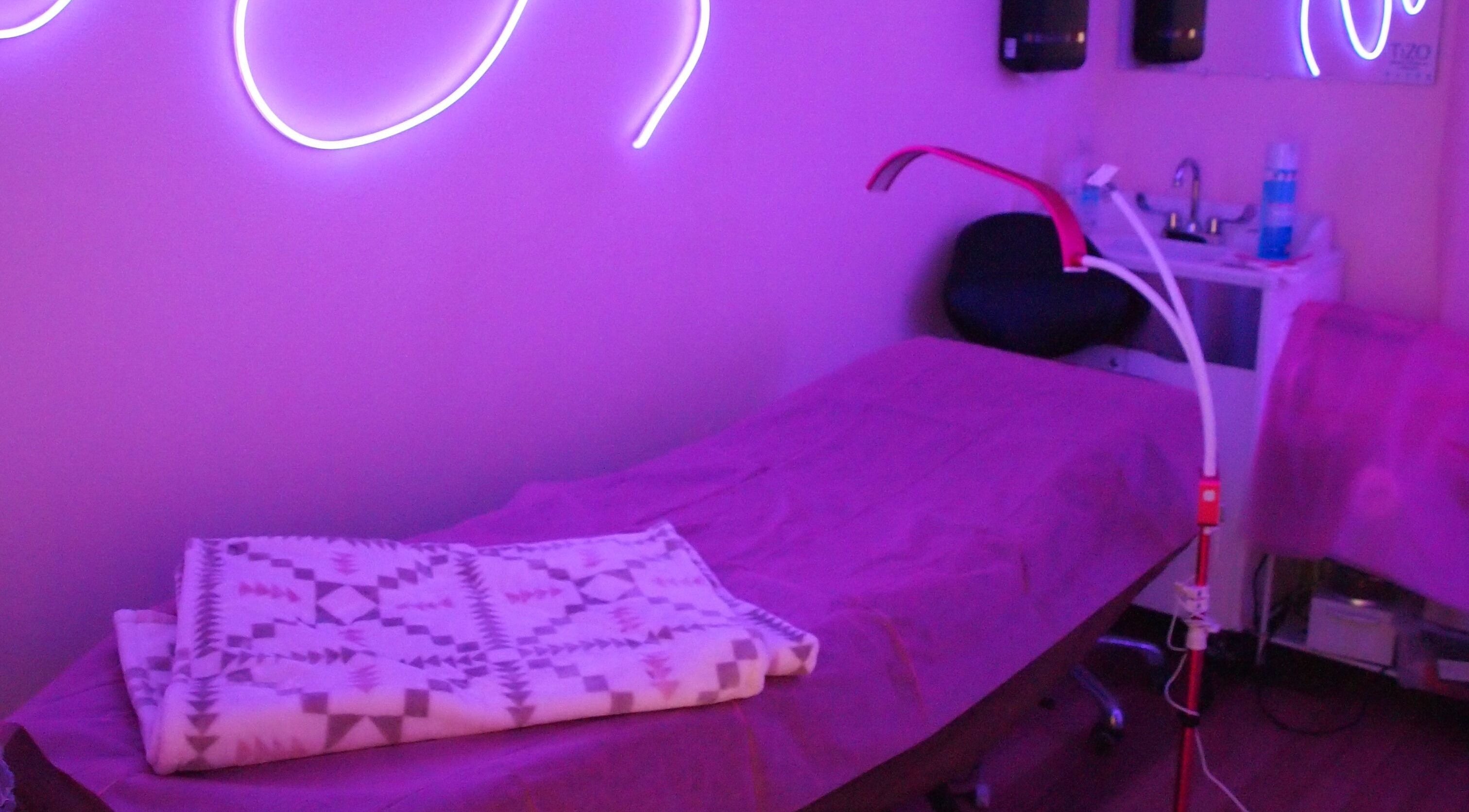 Tranquil treatment room at European Beauty, Everett, Washington, US, featuring soothing purple lighting.