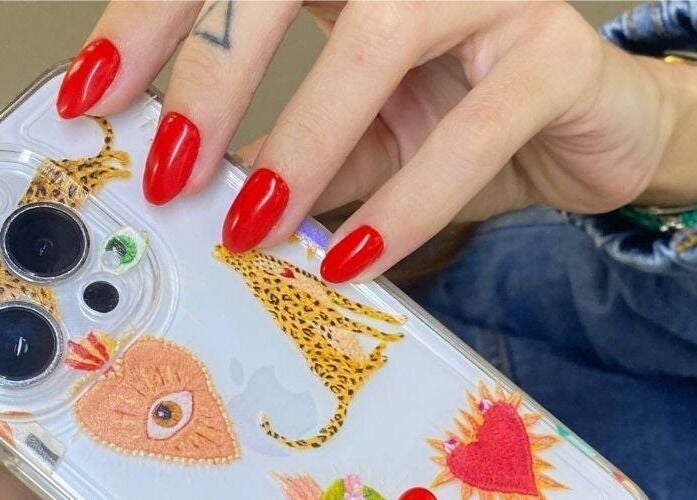 Vibrant red nails on a phone case at European Beauty in Everett, Washington, US.