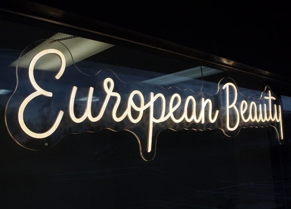 Illuminated European Beauty sign at Everett, Washington, US storefront.