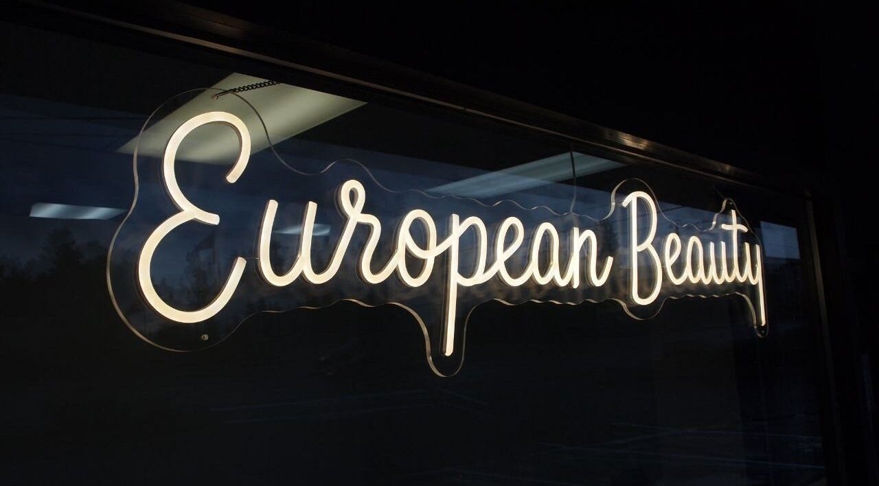 Illuminated European Beauty sign at Everett, Washington, US, showcasing elegant glowing design.