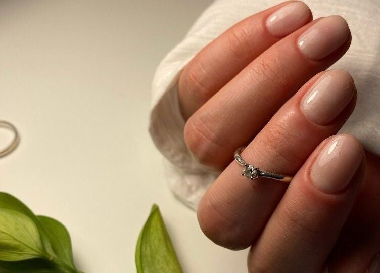 Elegant nude manicure with ring captured at European Beauty in Everett, Washington, US.