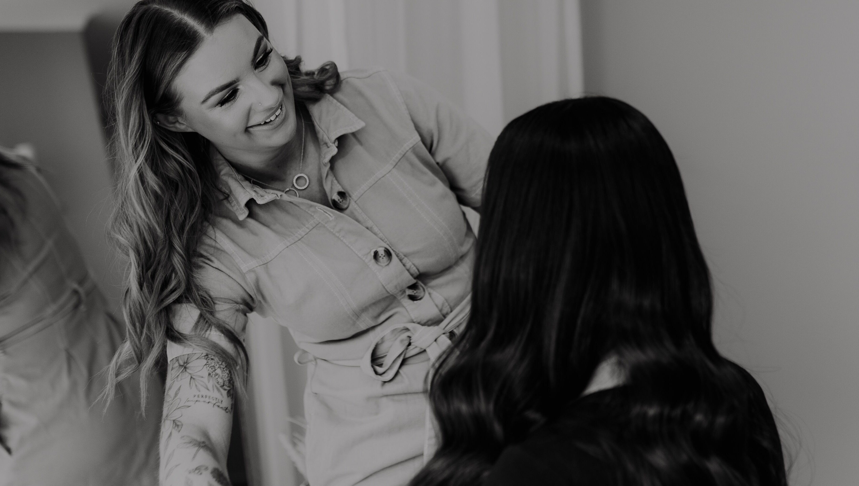 Hair By Alicia Louise stylist creating a look in Warragul, Victoria, AU. Smiling and working on a client's hair.