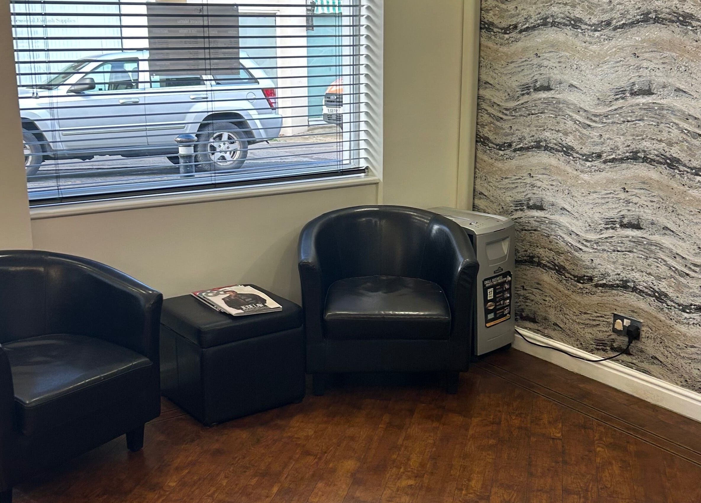 Cozy waiting area with black chairs at Beautify, Stanford-le-hope, England, GB.