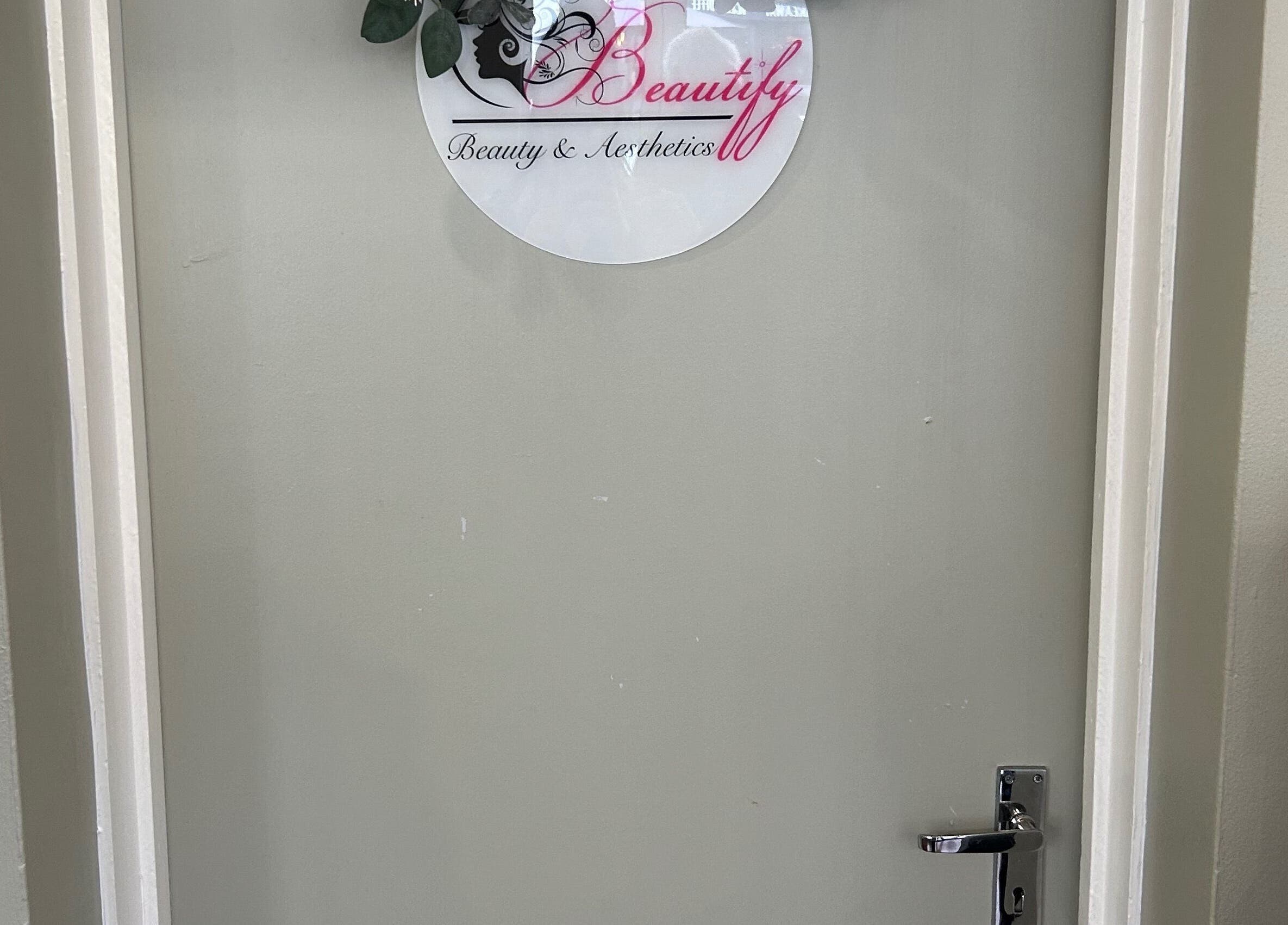 Entrance door of Beautify in Stanford-le-hope, England, GB featuring logo.