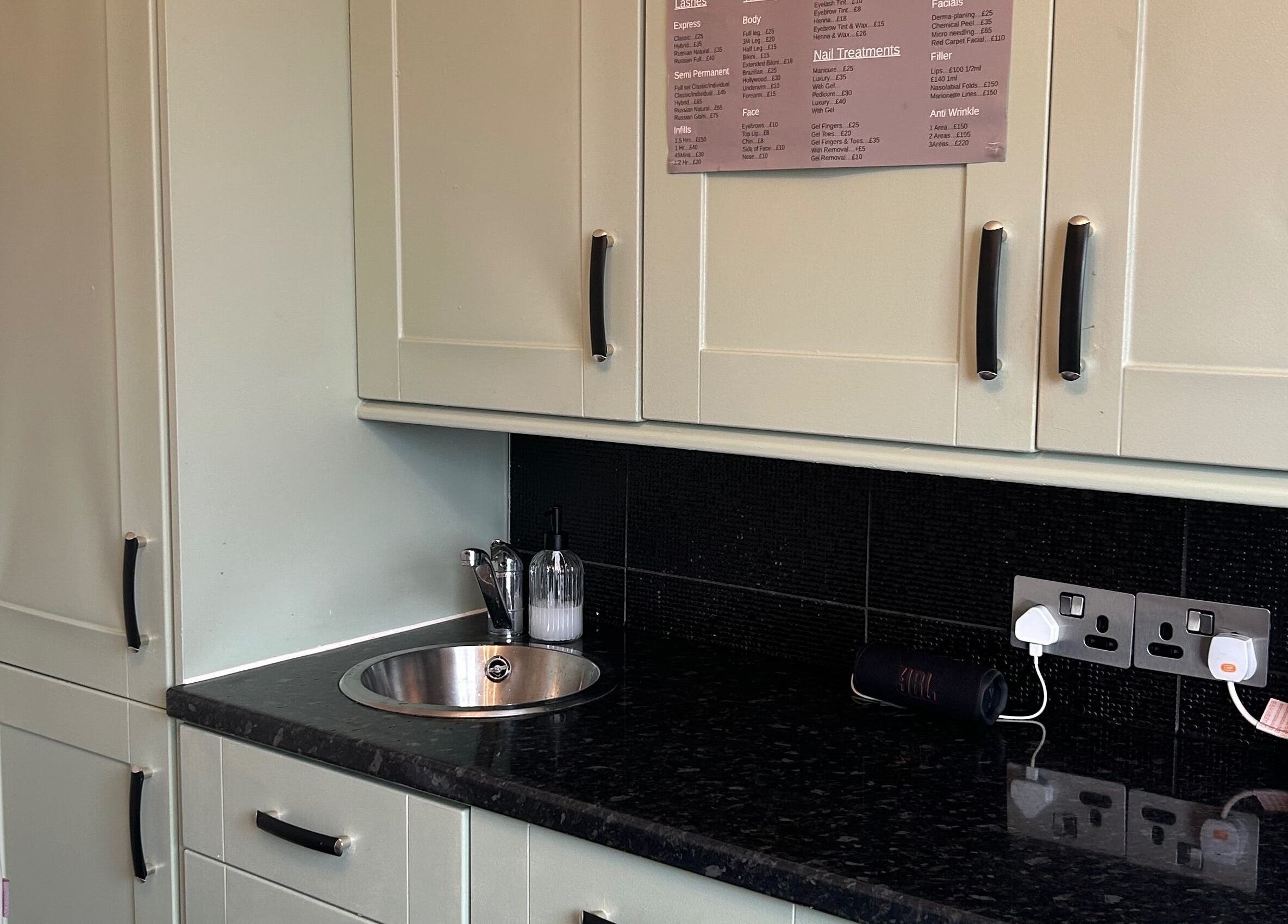 Modern kitchen setup at Beautify, Stanford-le-hope, England, GB showcasing stylish cabinets and countertop.