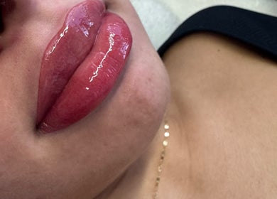 Glossy lip enhancement at Maria Ramos, London, England, GB. A close-up of perfectly balanced lip artistry.