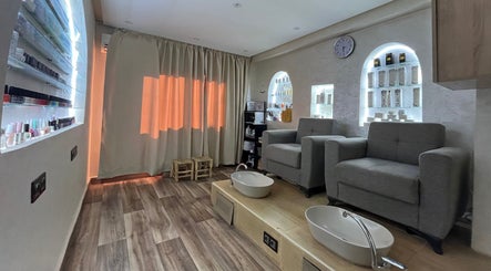 Relaxing pedicure room at Thai London Therapy Marrakesh, Marrakech-safi, MA with plush chairs and ambient lighting.