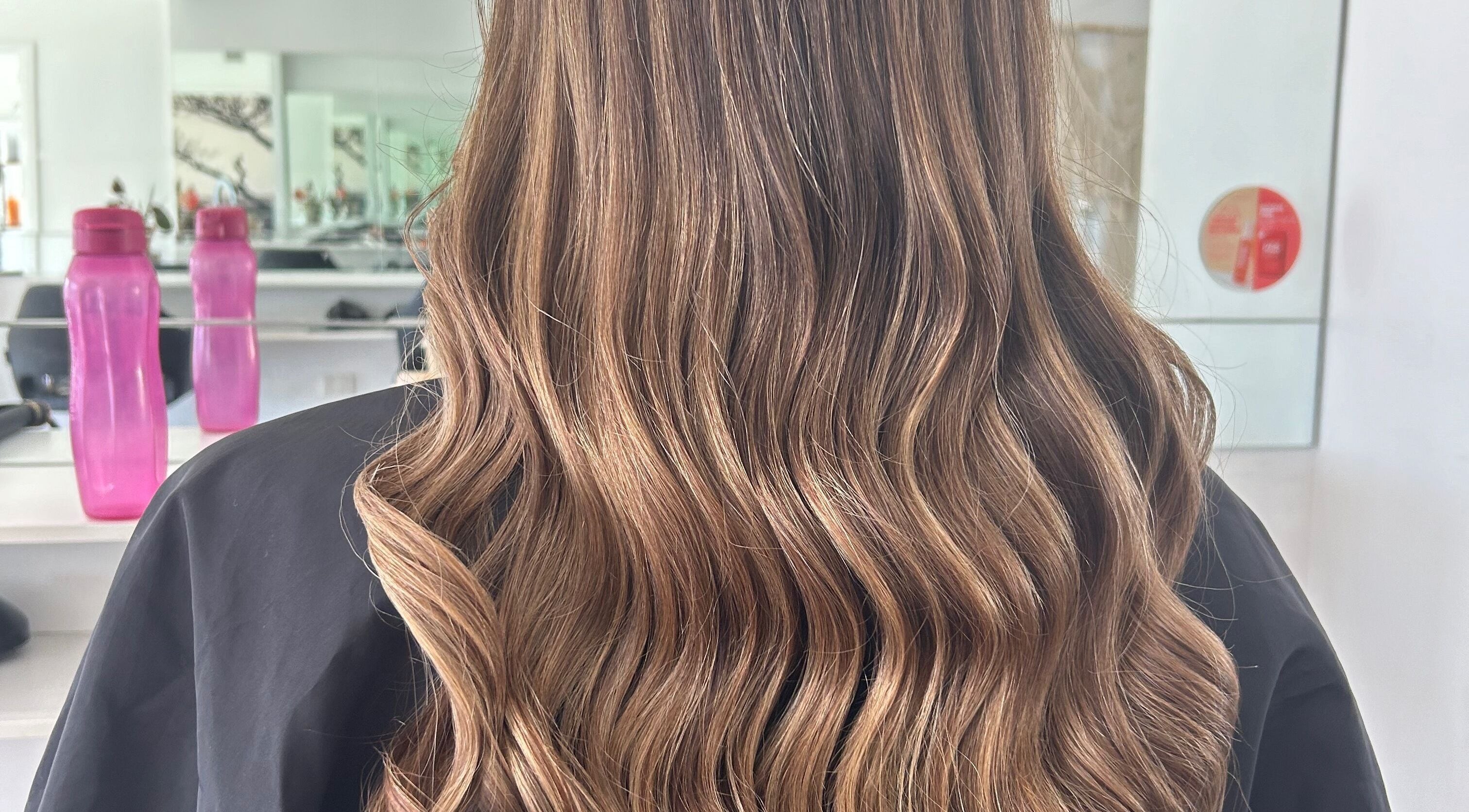 Elegant wavy hair styled at Styled by Jess Toohey, Marks Point, New South Wales, AU.