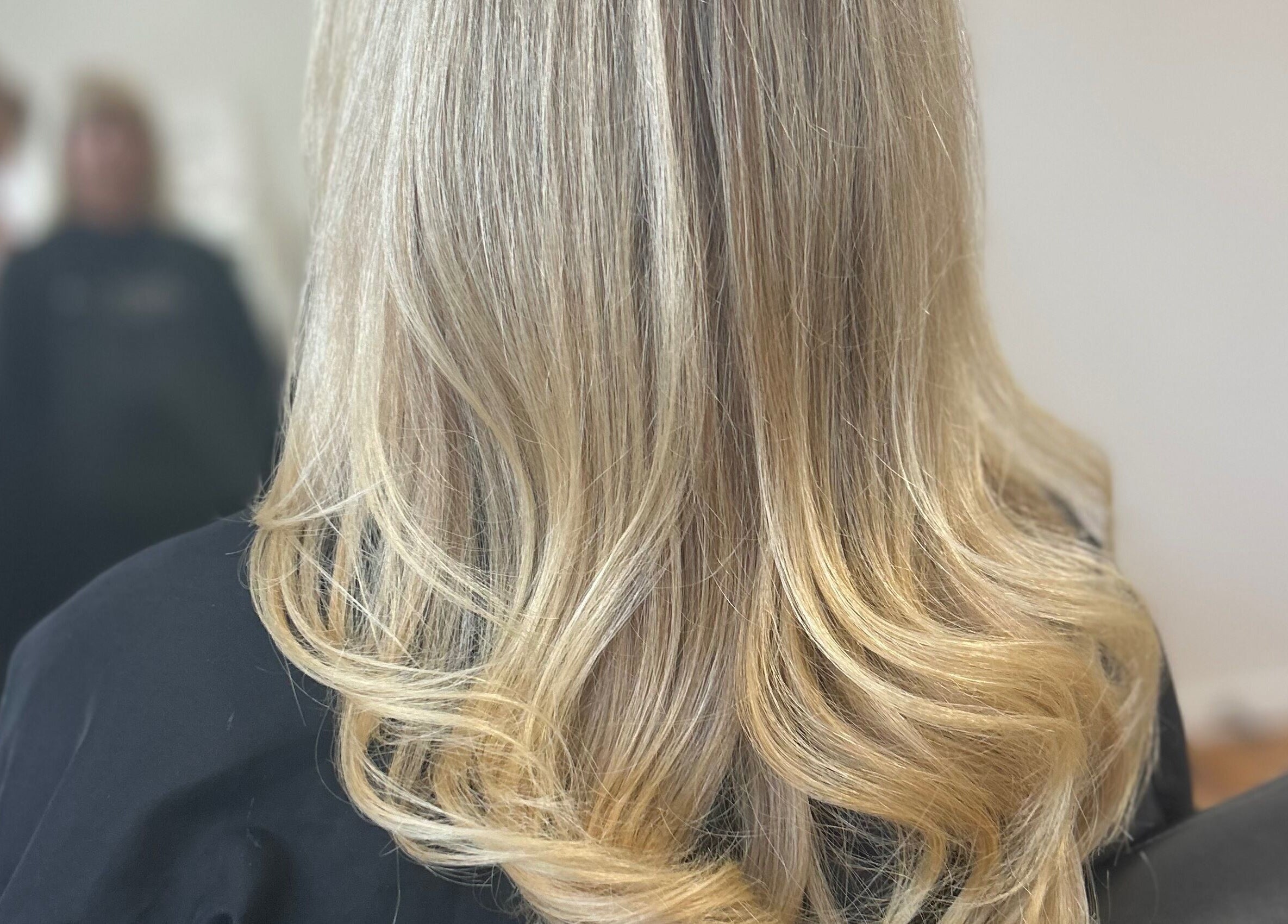 Blonde hair styled with soft waves at Styled by Jess Toohey, Marks Point, New South Wales, AU.