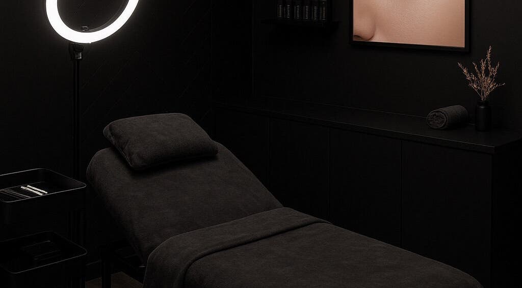 Elegant treatment room at Lash Element, Melbourne, Victoria, AU, showcasing a modern black spa bed and warm lighting.