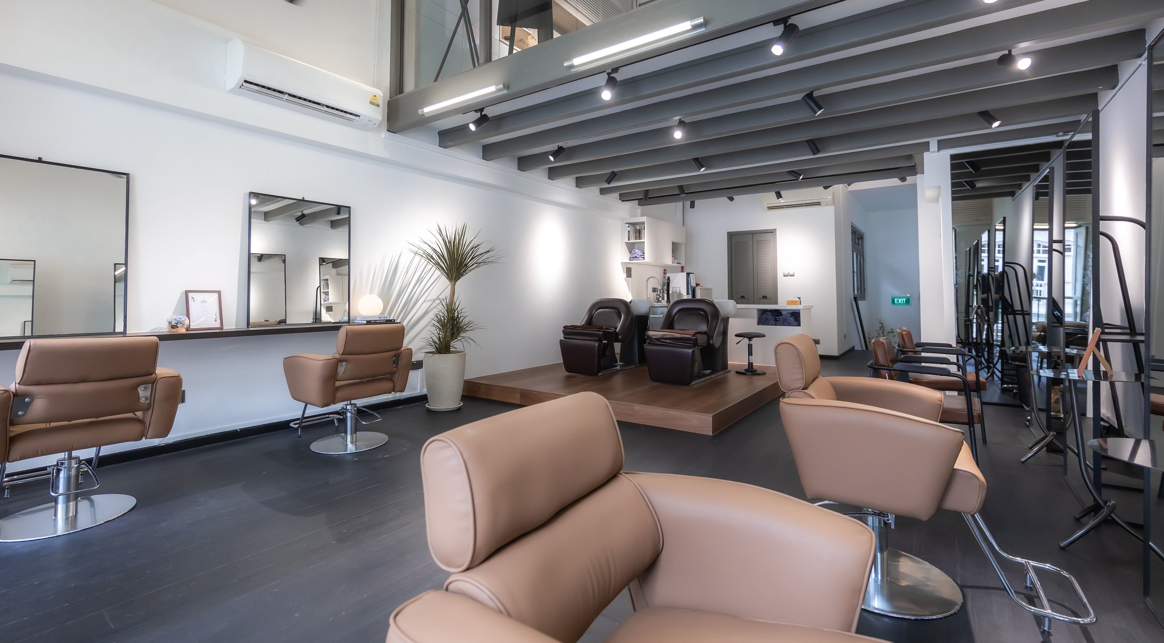Modern interior of KEI HAIR STUDIO in Singapore, SG, showcasing stylish salon chairs and mirrors.
