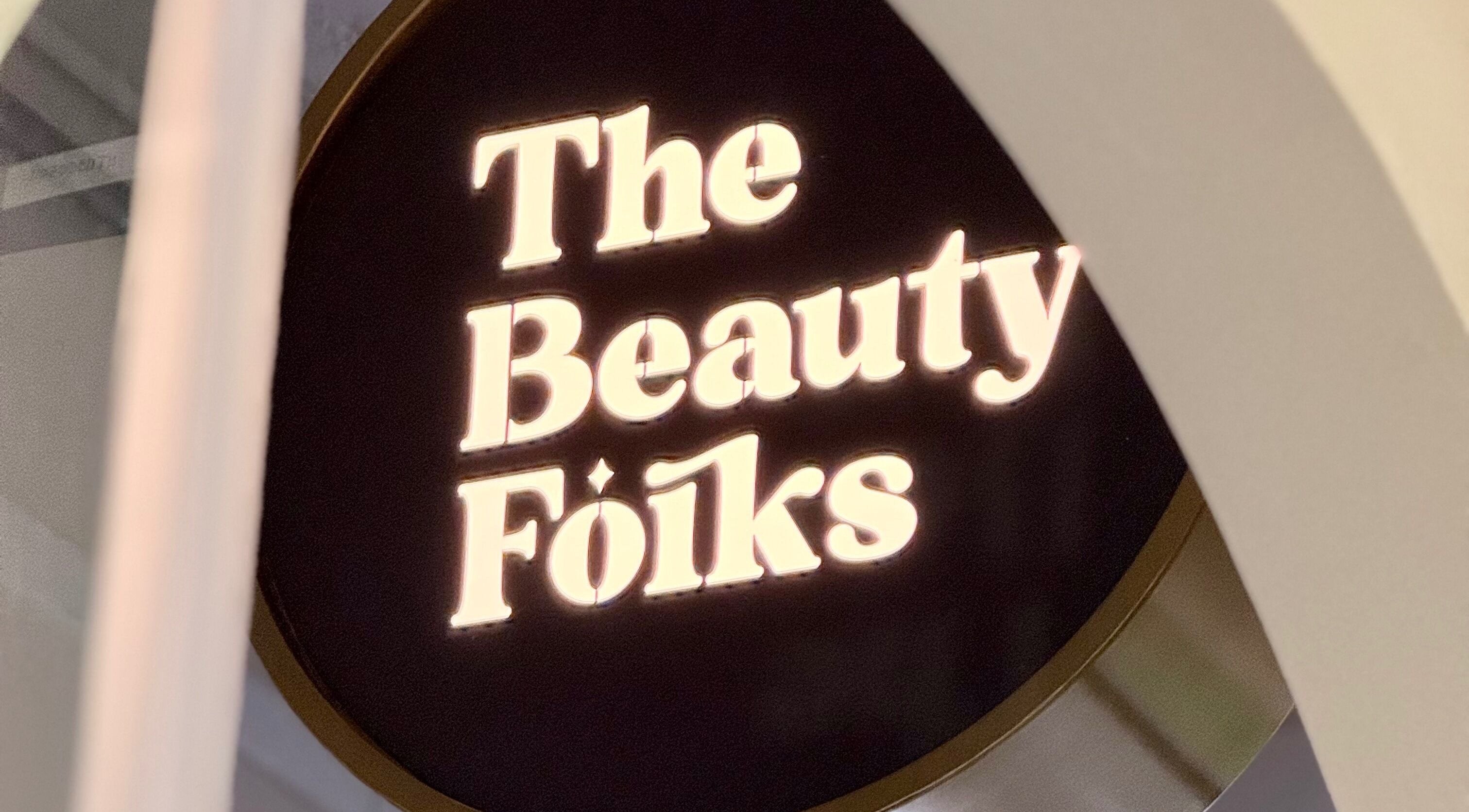 Illuminated sign of The Beauty Folks at Singapore, Singapore, SG enhancing venue entrance.