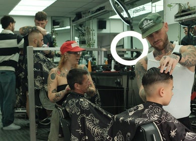Stylists creating trendy haircuts at Masters Barbershop, Brighton and Hove, England, GB.