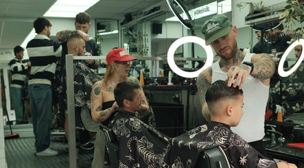 Stylists creating trendy haircuts at Masters Barbershop, Brighton and Hove, England, GB.
