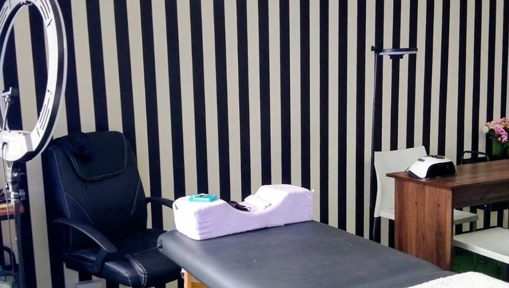 Modern beauty station at GRWM Beauty Bar & Academy in Gqeberha, Eastern Cape, ZA with black-striped walls.