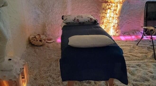 Tranquil salt room with massage table at Oasis of Healing Spa in Waterloo, Ontario, CA.