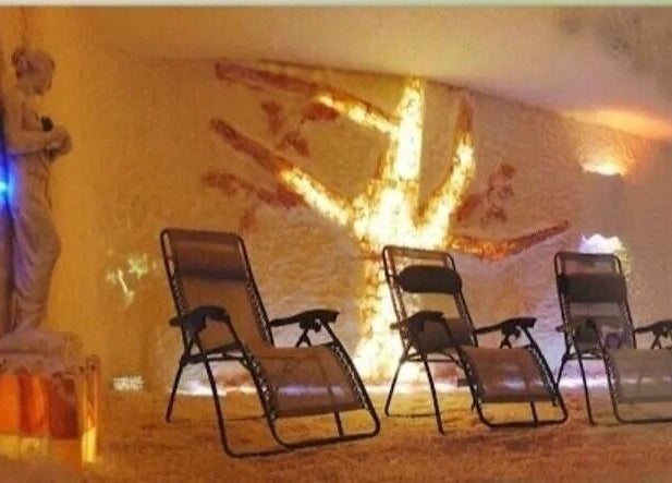 Relaxing salt room with reclining chairs at Oasis of Healing Spa in Waterloo, Ontario, CA for wellness therapy.