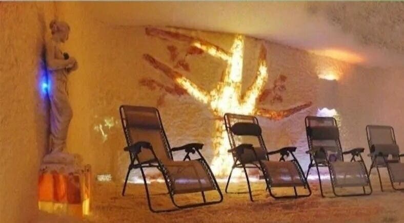 Relaxing salt room with reclining chairs at Oasis of Healing Spa in Waterloo, Ontario, CA for wellness therapy.