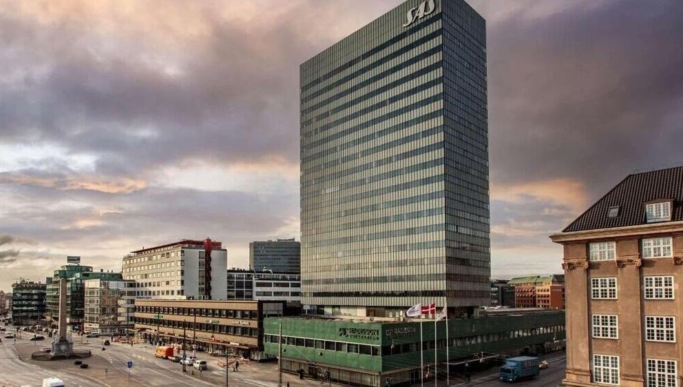 Radisson Collection Royal Hotel, Copenhagen, with cityscape in København, Denmark, DK at sunset.