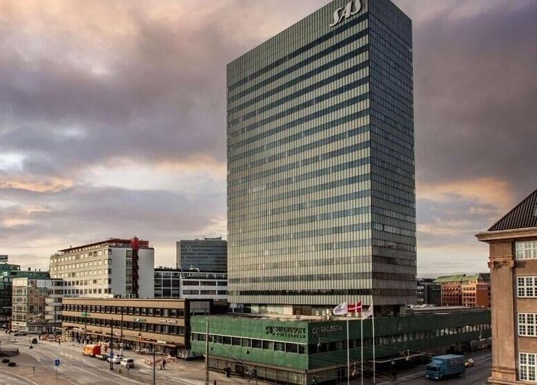 Radisson Collection Royal Hotel, Copenhagen, with cityscape in København, Denmark, DK at sunset.