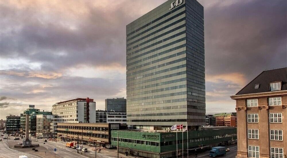 Radisson Collection Royal Hotel, Copenhagen, with cityscape in København, Denmark, DK at sunset.
